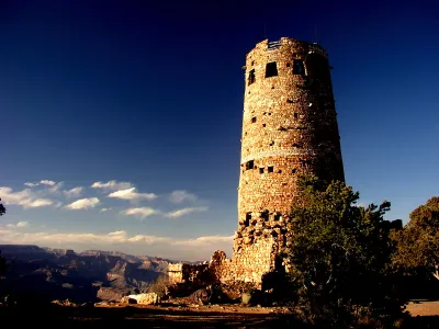 close up view of The Desert View Watchtower Perched on the edge of Grand Canyon, a surprising stone tower celebrates ancient mysteries of the Southwest. The Desert View Watchtower is a monument to a time, a place and a people. Architect Mary Colter built the Watchtower in 1932.